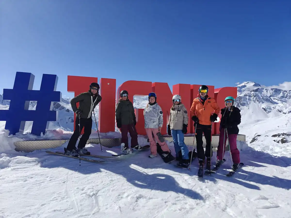 Peak Retreats Team Members By The Tignes Signs